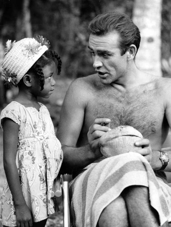 Sean Connery signs a coconut for a young Jamaican fan on the set of Dr. No in 1962.